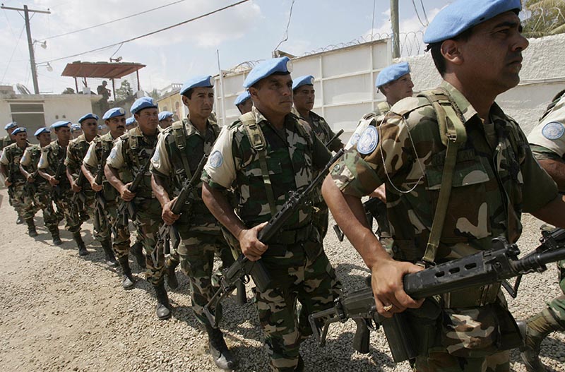 UN troops from Uruguay march during a transitional ceremony at the UN Spain base in Forte-Liberte, Haiti, on March 26, 2006.