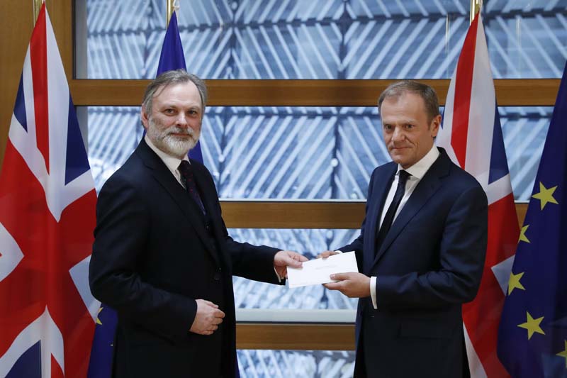 Britain's permanent representative to the European Union Tim Barrow, left, hand delivers British Prime Minister Theresa May's Brexit letter in notice of the UK's intention to leave the bloc under Article 50 of the EU's Lisbon Treaty to EU Council President Donald Tusk, in Brussels, Belgium, Wednesday, March 29, 2017. Photo: AP