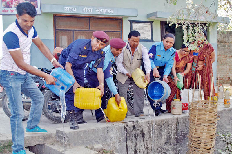 Nepal police personnel and locals destroy alcohol seized from Nagawa and New Bus Park area in Birgunj, on Friday, March 3, 2017. Photo: RSS