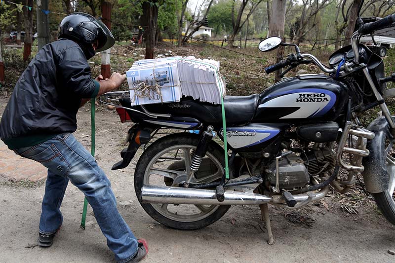 A man loads school textbooks on his motorcycle for the new academic session at the Sanothimi-based Janak Education Materials Centre in Bhaktapur district, on Sunday, March 19, 2017. Photo: RSS