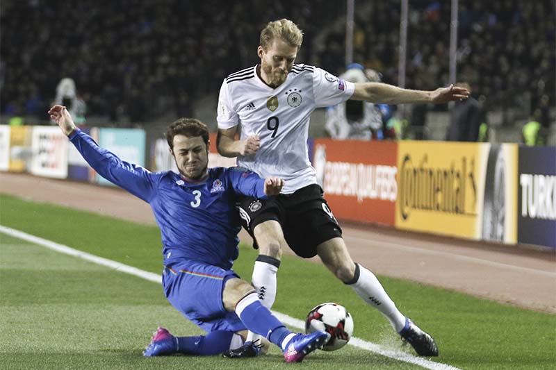 Germany's Andre Schurrle, right, and Azerbaijan's Majored Mirzabekov challenge for the ball during their World Cup Group C qualifying match at the Tofig Bahramov Stadium in Baku, Azerbaijan, on Sunday March 26, 2017. Photo: AP