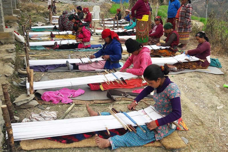 Women of Magar community learn to weave traditional Bhangra costumes, in Kuhun of Myagdi district on Sunday, March 12, 2017. Photo: RSS