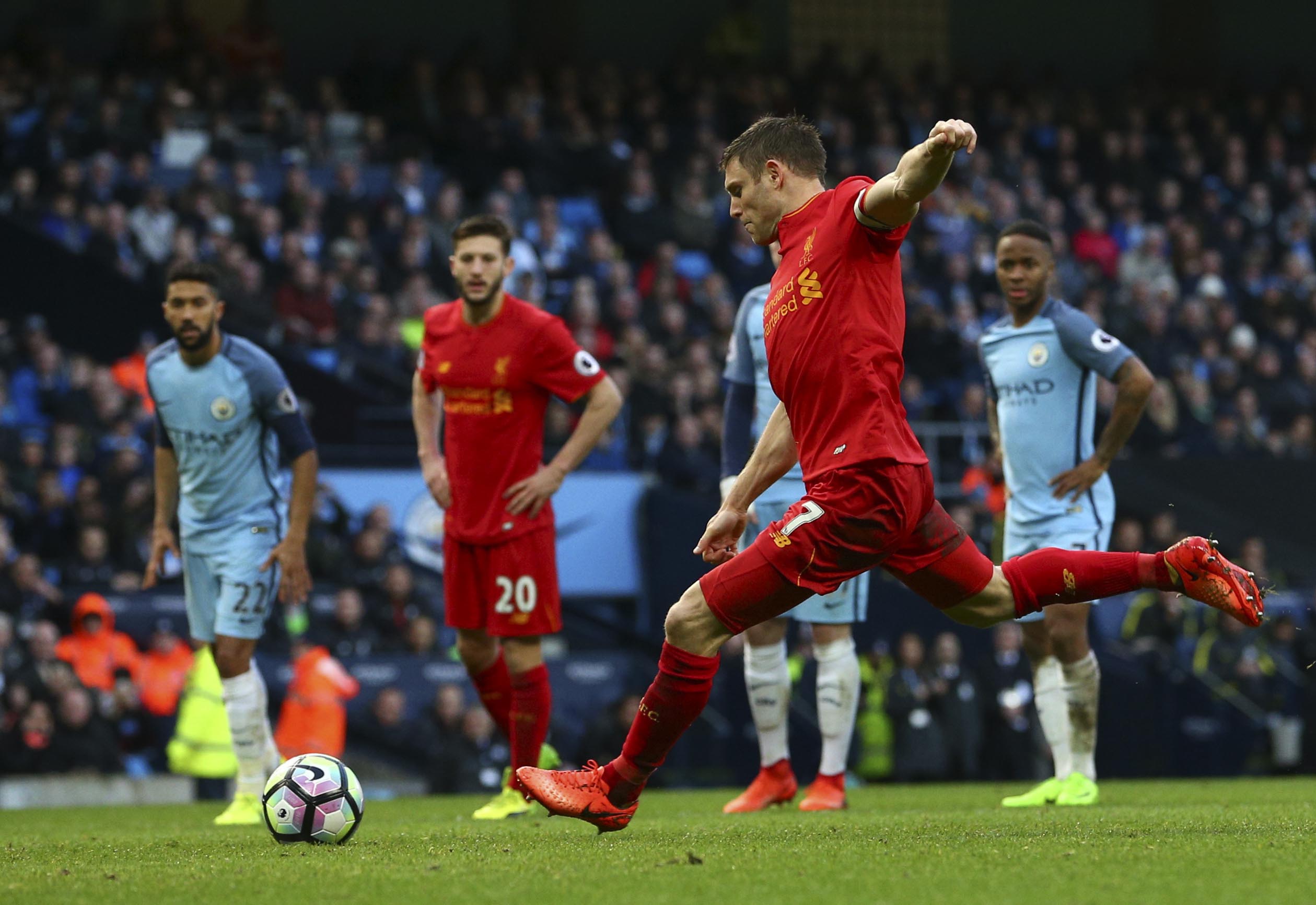 Liverpool's James Milner scores the opening goal from the penalty spot during the English Premier League soccer match between Manchester City and Liverpool at the Etihad Stadium in Manchester, England, on Sunday March 19, 2017. Photo: AP