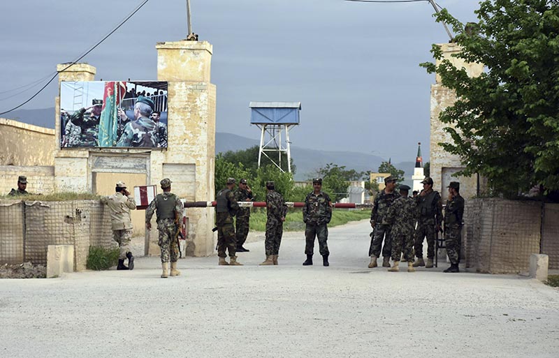 Afghan soldiers stand guard at the gate of a military compound after an attack by gunmen in Mazar-e- Sharif province north of kabul, Afghanistan, on Friday, April 21, 2017. Photo: AP