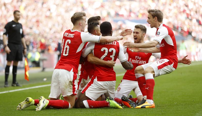 Arsenal's Alexis Sanchez celebrates scoring their second goal with team mates. Photo: Reuters