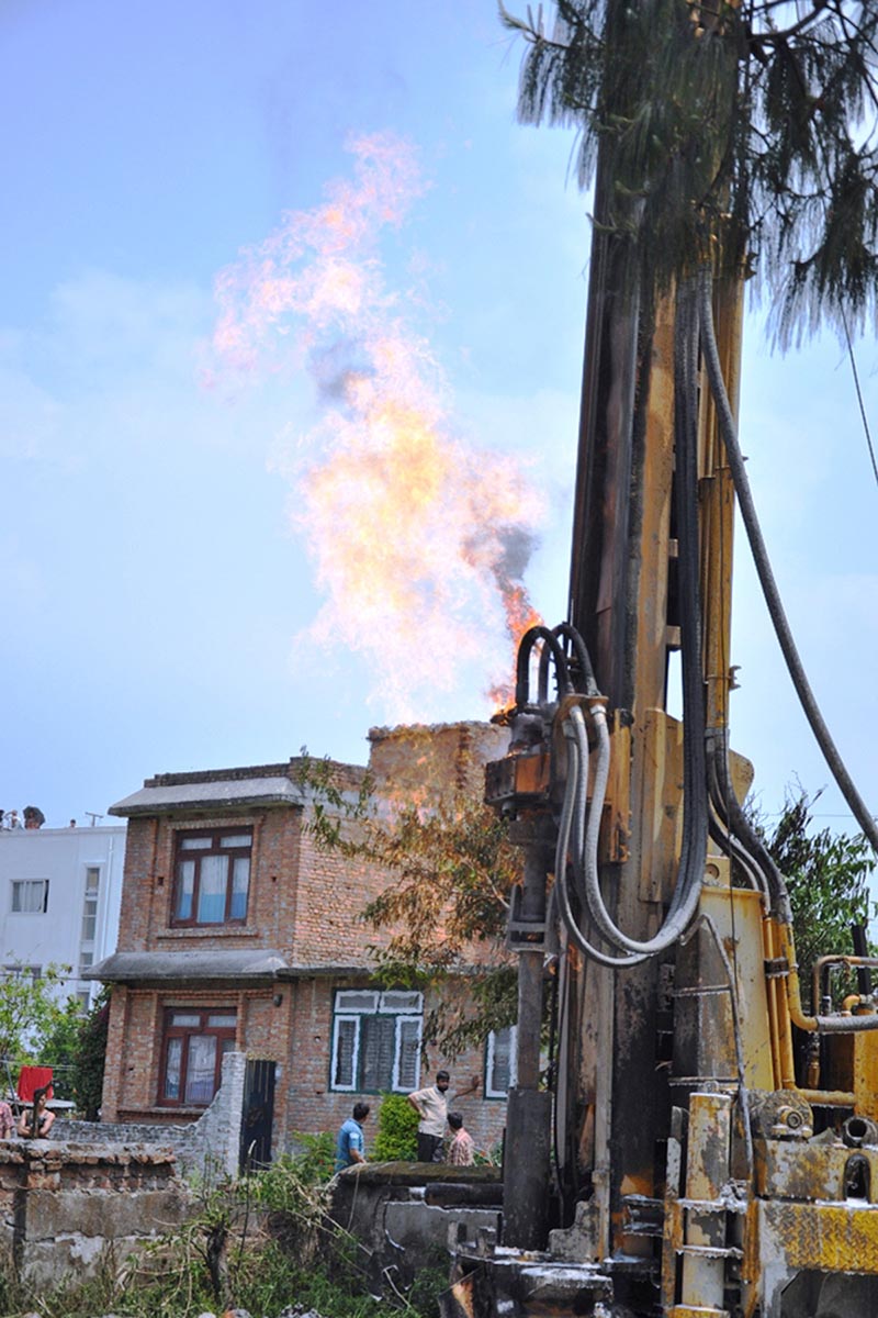 A fire plume rises above equipment used for water deep boring in Sirutar of Bhaktapur: RSS