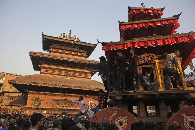 Nepalese youth climb on the chariot of Hindu god Bhairava as devotees pull it during the annual Bisket Jatra Festival in Bhaktapur, Nepal, Monday, April 10, 2017. The week long festival ends on April 18. (AP Photo/Niranjan Shrestha)