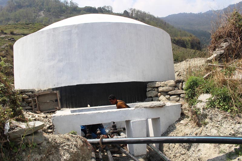 Plumbers are seen installing pipes into a newly constructed drinking water tank in Raghuganga-1 in Myagdi district, on Wednesday, April 12, 2017. Photo: RSS