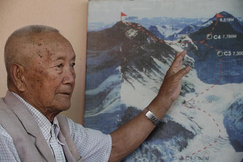 Nepali mountain climber Min Bahadur Sherchan, points to a picture to describe the trail to Mount Everest, as he talks to Associated Press at his residence in Kathmandu, Nepal, on Tuesday, April 11, 2017. Photo: AP