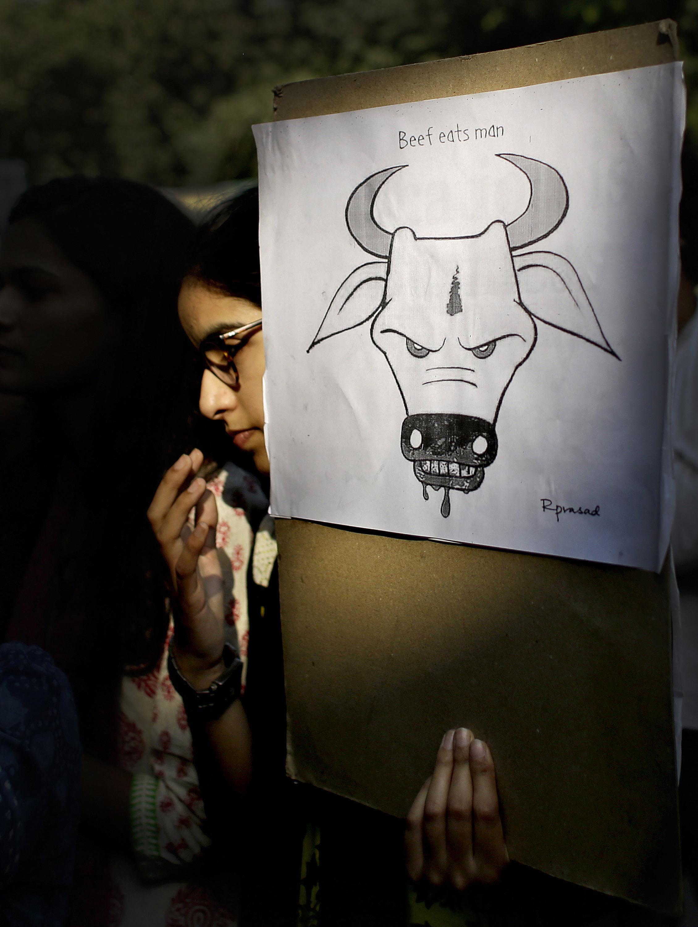 FILE - A student activist holds a placard during a protest denouncing the killing of a 52-year-old Muslim farmer Mohammad Akhlaq by villagers upon hearing rumors that the family was eating beef, a taboo for many among India's majority Hindu population, in New Delhi, India, on October 2, 2015. Photo: AP
