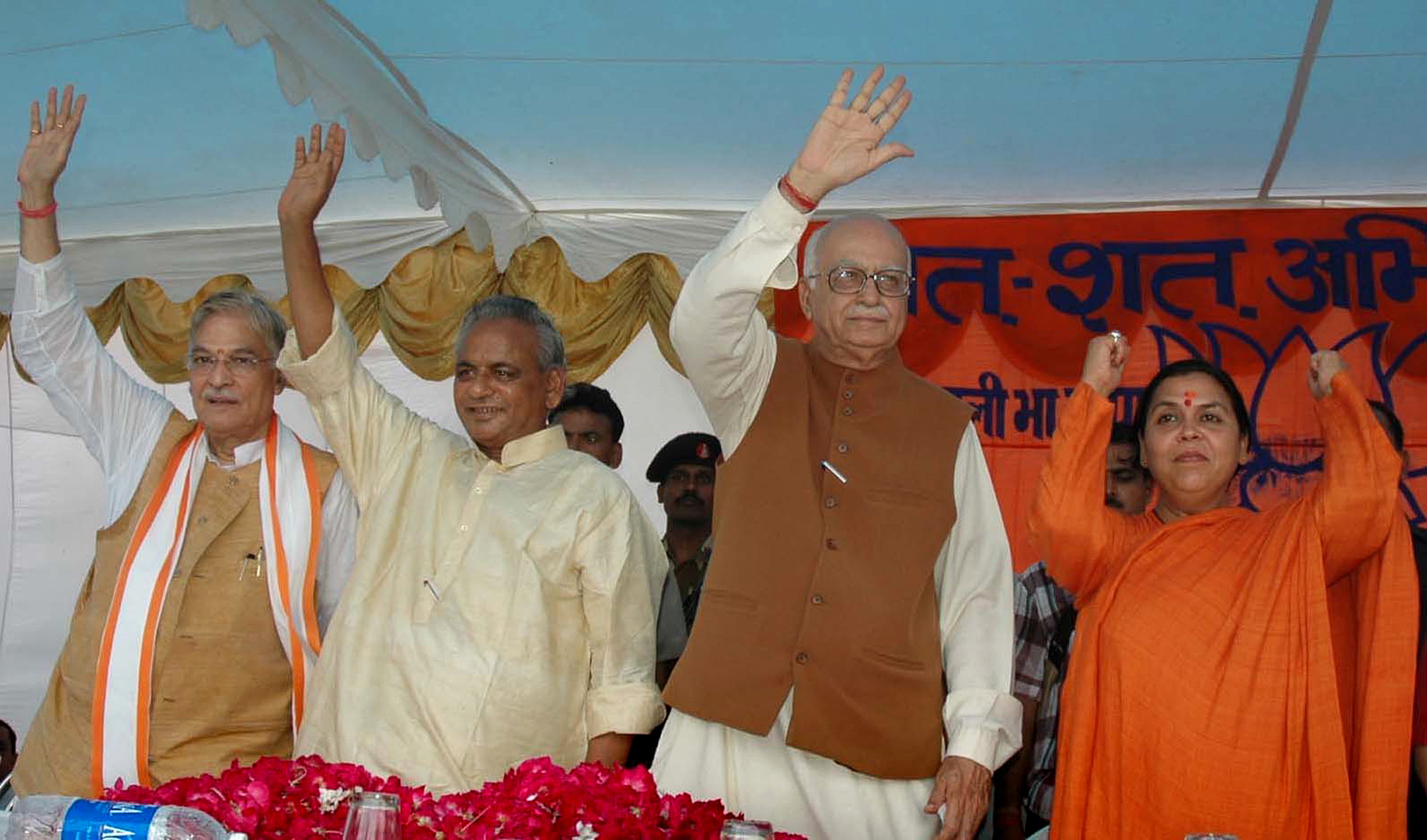 FILE - In this July 28, 2005 file photo, Indian opposition leader and President of the Bharatiya Janta Party (BJP) L.K. Advani, second right, senior BJP leaders Uma Bharati, right, Kalyan Singh, second left, and Murli Manohar Joshi wave to people during a public rally in Rae Bareilly, in the northern Indian state of Uttar Pradesh. India's top court said Wednesday, April 19, 2017, that the four senior leaders of India's ruling Hindu nationalist Bharatiya Janata Party will stand trial for their role in a criminal conspiracy over the destruction of the 16th century Babri mosque in 1992, an event that sparked bloody nationwide rioting. Of the four main leaders who will now stand trial, Singh is currently the governor of an Indian province, and the constitution protects him from criminal trial. Therefore his trial will start after his term ends. (AP Photo/Rajesh Kumar Singh, File)