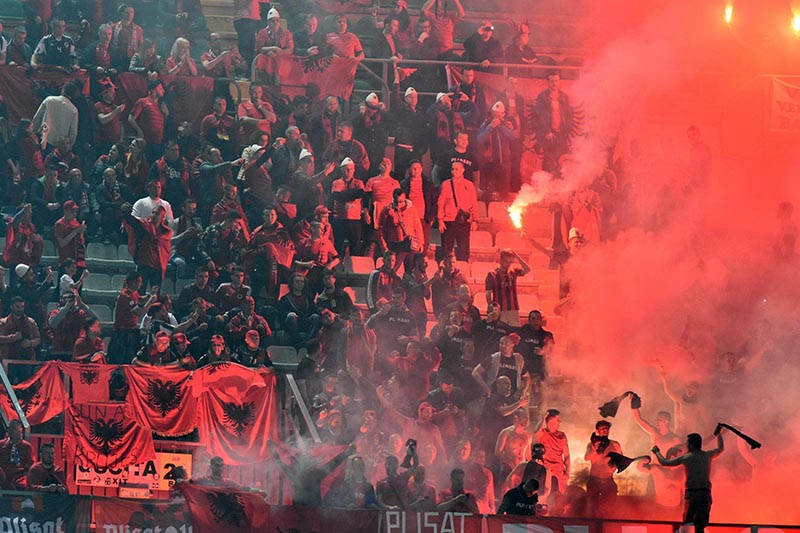 FILE- Albania's supporters light flares during a 2018 World Cup Group G qualifying soccer match between Italy and Albania, at the Renzo Barbera stadium, in Palermo, Italy, on Friday, March 24, 2017. Photo: Mike Palazzotto/ANSA via AP