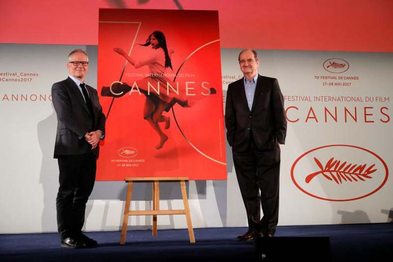 Cannes Film festival general delegate Thierry Fremaux (left) and Cannes Film festival president Pierre Lescure (right) pose in front of the official poster for the 70th Cannes Film Festival after a news conference, to announce this year's official selection, in Paris, France, on April 13, 2017. Photo: Reuters