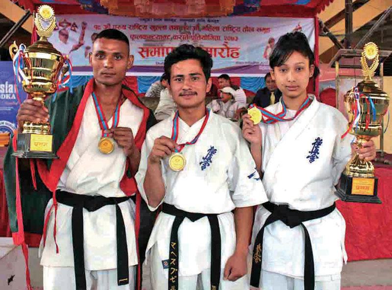 (From left) Gold medallists Sani Singh Sunar, Mahesh Bhujel and Ambika Bhujel after the 19th Menu0092s and 12th Womenu0092s Weight Category National Full-contact Karate Tournament in Kathmandu on Wednesday, April 12, 2017. Photo: THT