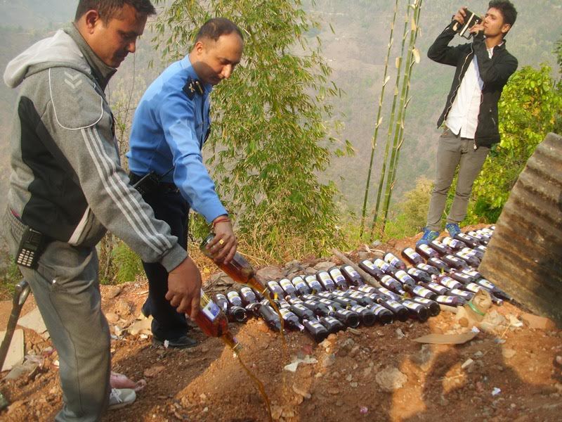 Panchthar District Police Office destroying smuggled liquor from the adjoining Sikkim on April 12, 2017. Photo: Laxmi Gautam