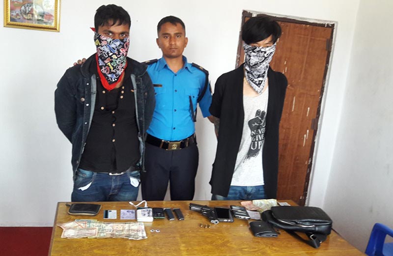 Pakali-based Area Police Office parades two men along with a US-manufactured pistol and bullets they possessed, in Sunsari district, on Saturday, April 22, 2017. Photo: Yam Pradhan via RSS