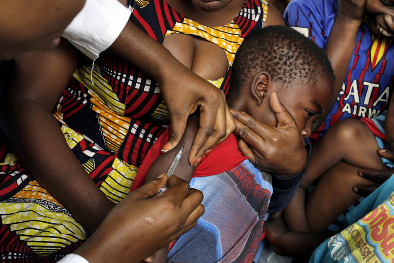 FILE -In this July 21, 2016 file photo, residents of the Kisenso district of Kinshasa, receive yellow fever vaccines. Photo: AP
