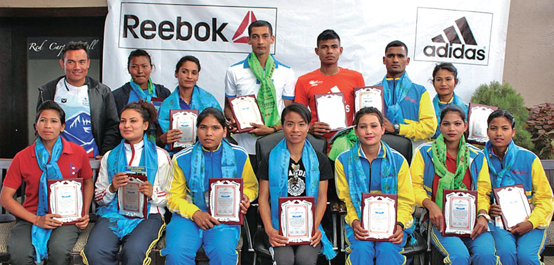 Legendary athletes and international medallists take group photo with letter of felicitation during the felicitation program organized by Nepal Athletics Assciation at Red Carpet, Sherpa Mall, Durbar Marg in Kathmandu, on Saturday. Photo: THT