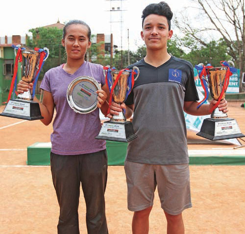 Ira Rawot (left) and Samrakshyak Bhushan Bajracharya respectively women's singles and men's singles winners take photo with their winners' trophies after prize distribution ceremony of the Fifth Citizens Bank Open Tennis Tournament at the Dasharath Stadium courts in Tripureshwor, Kathmandu on Saturday. Photo: Udipt Singh Chhetry