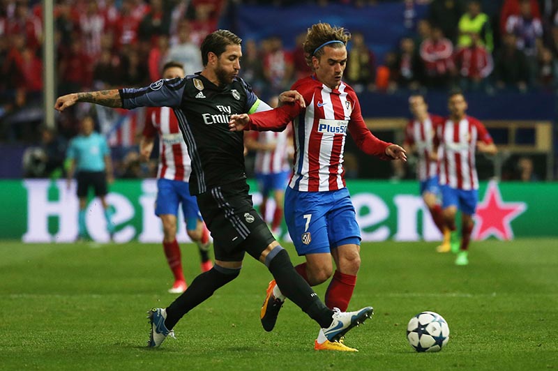 Atletico Madrid's Antoine Griezmann in action with Real Madrid's Sergio Ramos. Photo: Reuters