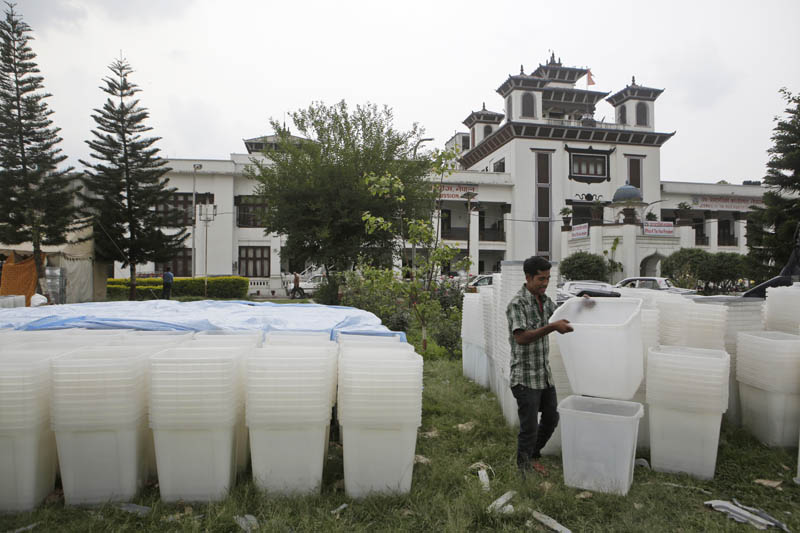 A Nepali election commission staff arranges ballot boxes and other polling material Kathmandu, Nepal, Wednesday, May 3, 2017. Photo: AP