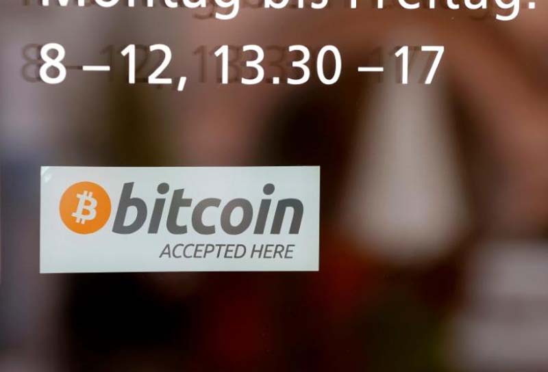 A sticker reading ''Bitcoin accepted here'' is displayed at the entrance of the Stadthaus town hall in Zug, Switzerland, on August 30, 2016. Photo: Reuters