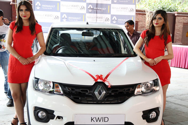 Models pose with a newly launched car in Kathmandu, on Wednesday, May 10, 2017. Photo: RSS