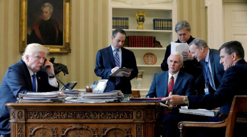 US President Donald Trump (left to right), joined by Chief of Staff Reince Priebus, Vice President Mike Pence, senior advisor Steve Bannon, Communications Director Sean Spicer and then National Security Advisor Michael Flynn, speaks by phone with Russia's President Vladimir Putin in the Oval Office at the White House in Washington, US on January 28, 2017. Photo: Reuters