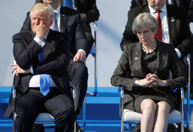US President Donald Trump (left) and Britain's Prime Minister Theresa May react during a ceremony at the new NATO headquarters before the start of a summit in Brussels, Belgium, on May 25, 2017. Photo: Reuters