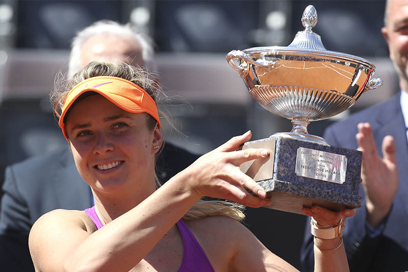 Svitolina holds the trophy after her victory. Photo: Reuters
