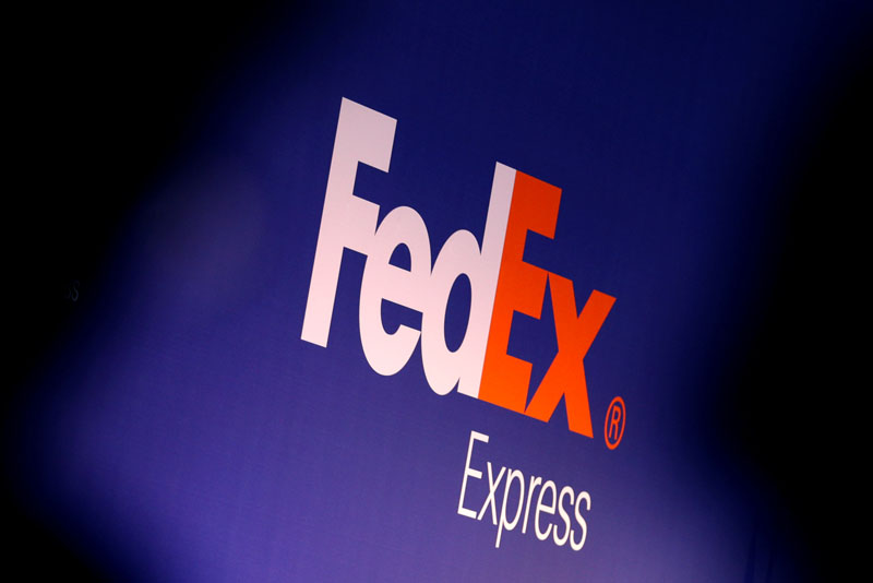 People stand near the FedEx Express logo during the presentation of the future extension of the FedEx hub in Roissy-en-France, North of Paris, France, on October 18, 2016. Photo: Reuters