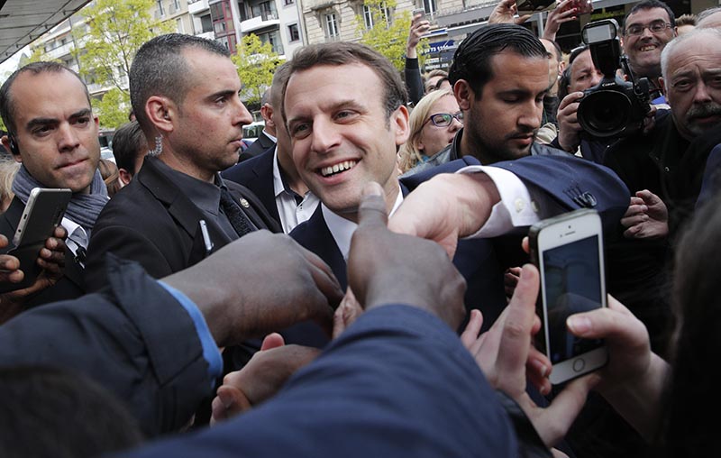 French independent centrist presidential candidate Emmanuel Macron shakes hands to supporters as he campaigns in Rodez, southern France, on Friday, May 5, 2017. Photo: AP