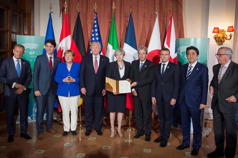 European Council President Donald Tusk, Canadian Prime Minister Justin Trudeau, German Chancellor Angela Merkel, US President Donald Trump, Britainu2019s Prime Minister Theresa May, Italian Prime Minister Paolo Gentiloni, French President Emmanuel Macron, Japanese Prime Minister Shinzo Abe,  and European Commission President Jean-Claude Juncker pose after signing the 'G7 Taormina Statement on the Fight Against Terrorism and Violent Extremism' at the G7 summit in Taormina, Sicily, Italy, May 26, 2017. Photo: Guido Bergmann/Courtesy of Bundesregierung/Handout via Reuters