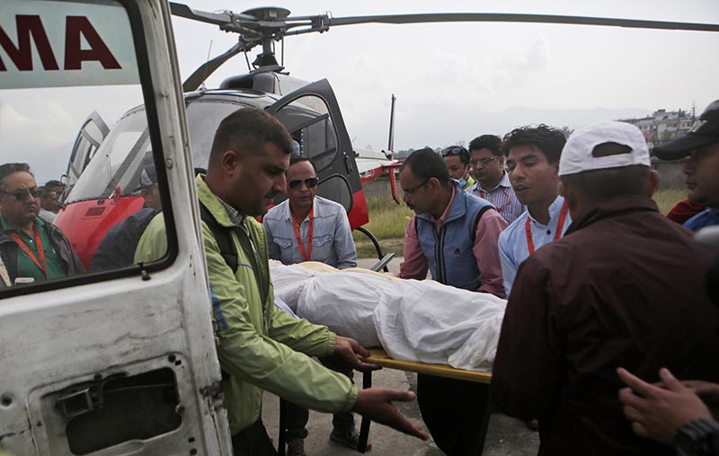 Officials loading bodies of pilots of the Goma Air aircraft, which crashed in Lukla on Saturday, into an ambulance, in Kathmandu, on Sunday, May 28, 2017. Photo: AP