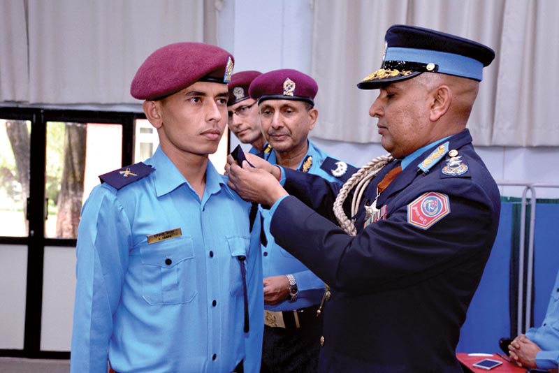 Inspector General of Police Prakash Aryal conferring insignia on a newly recruited inspector, in Kathmandu, on Wednesday, May 24, 2017. Photo: THT