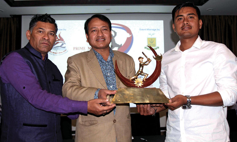 (From left) Head coach Jagat Tamatta, NSC Member Secretary Keshab Kumar Bista and Nepal national cricket team vice-captain Gyanendra Malla hold the first Prime Minister Cup trophy at a press meet in Kathmandu on Thursday, May 11, 2017. Photo: THT
