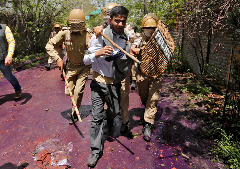 File - Indian policemen detain a Kashmiri student during a protest in Srinagar on April 24, 2017. Photo: Reuters