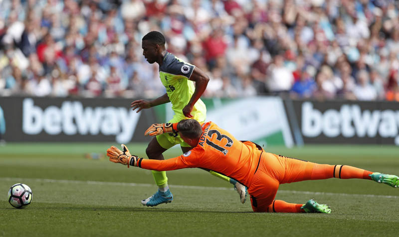 Liverpool's Daniel Sturridge scores their first goal past West Ham United's Adrian. Photo: Reuters
