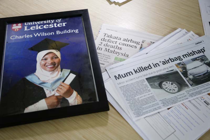 A portrait of Nida Fatin Mat Asis, a Malaysian doctor who died after being allegedly struck by a defective air bag inflator, next to news clippings in Kuala Lumpur, Malaysia, on November 5, 2016. Photo: AP