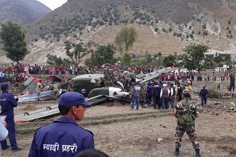 People examine the Nepal Army's PZL M-28 Skytruck cargo aircraft NA-048 that crashed in a field of Kolti Airport in Bajura district, on Tuesday, May 30, 2017. Photo: Prakash Singh/THT