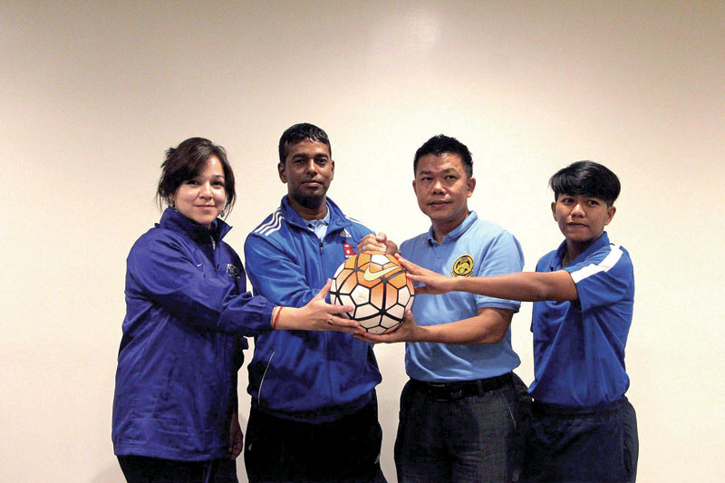 (From left) Nepal national women's football team manager Shivanee Thapa, coach Kumar Thapa, Malaysian coach Mohdasyraaf Fong Abdullah and captain Masturah Majid pose for a photo at a pre-match conference in Kote Kinabalu on Sunday, May 21, 2017. Photo Courtesy: NSJF