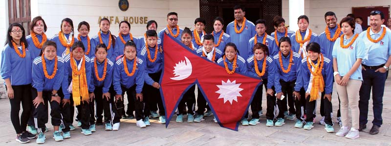Nepali womenu0092s national football team players and officials pose for a group photo at a farewell programme in Lalitpur on Friday. Photo: THT