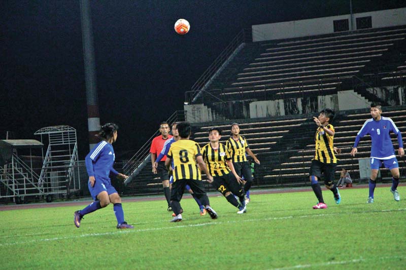 Players of Nepal (blue jersey) and Malaysia in action during their friendly football match at the Stadium Likas in Kote Kinabalu, on Monday. Photo Courtesy: NSJF