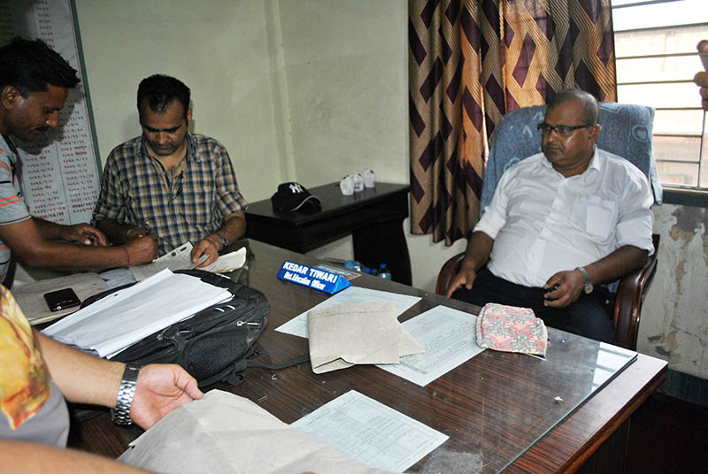 CIAA team investigating documents after arresting DEO and an Engineer red-handed while taking bribe from their client in Parsa on Thursday, May 25, 2017. Photo: Ram Sarraf