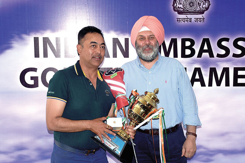 Pavitra Kumar Karki (left) receiving the trophy from Indian Ambassador to Nepal Manjeev Singh Puri after the Indian Ambassador's Cup at the Gokarna Golf Club in Kathmandu on Saturday, May 13, 2017. Photo Courtesy: Gokarna Golf Club