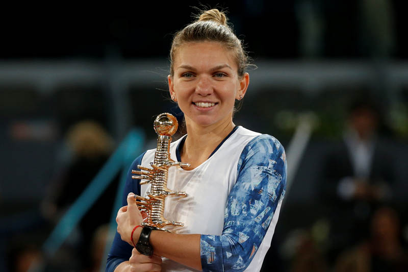 Halep poses with the trophy after her victory. Photo: Reuters