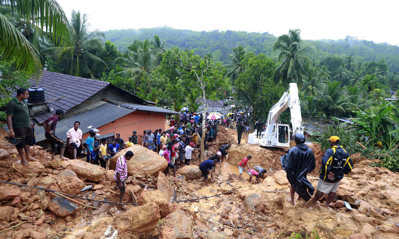 Sri Lankans watch military rescue efforts at the site of a landslide at Bellana village in Kalutara district, Sri Lanka, on Friday, May 26, 2017. Photo: AP
