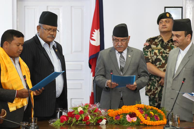 The newly appointed State Minister for Federal Affairs and Local Development Janak Raj Chaudhary being sworn in by Prime Minister Pushpa Kamal Dahal at the Office of Prime Minister and Ministry of Councils at Singhadurbar on May 12, 2017.
