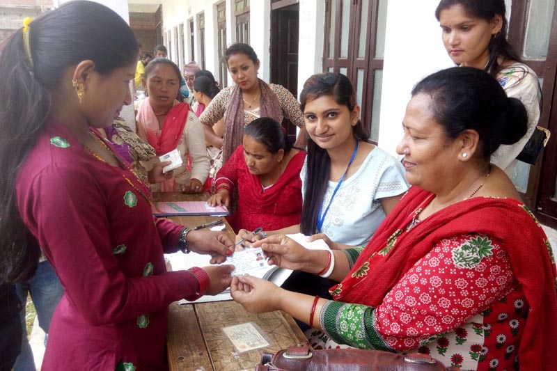 Voters receiving Voter Identity Cards at Battar Polling Centre in Nuwakot on Saturday, May 13, 2017. Photo: RSS