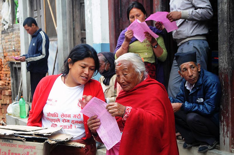 An elderly woman reading election pamphlets distributed by local cadres in Khokana, Lalitpur, on Tuesday, May 9, 2017. Photo: Balkrishna Thapa Chhetri/THT
